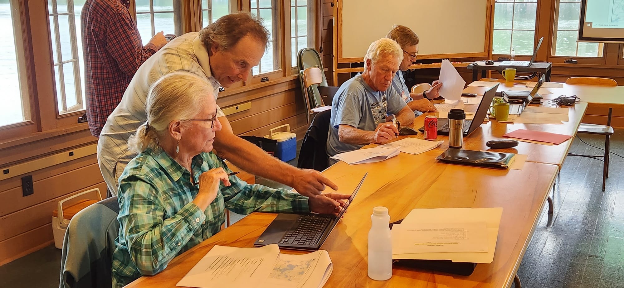 people at tables with laptops
